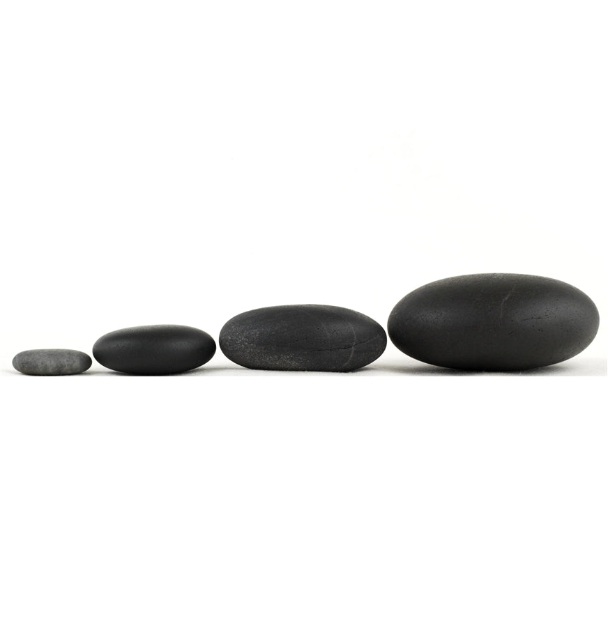 Authentic Basalt Stones. Four rounded black stones lined up from small to large.
