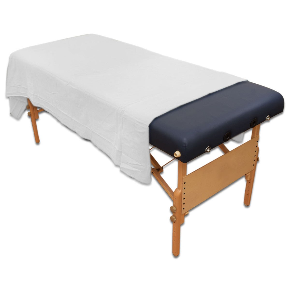 White flannel flat sheet laid over a massage table with black upholstery and wood frame | Equip Wellness Collective