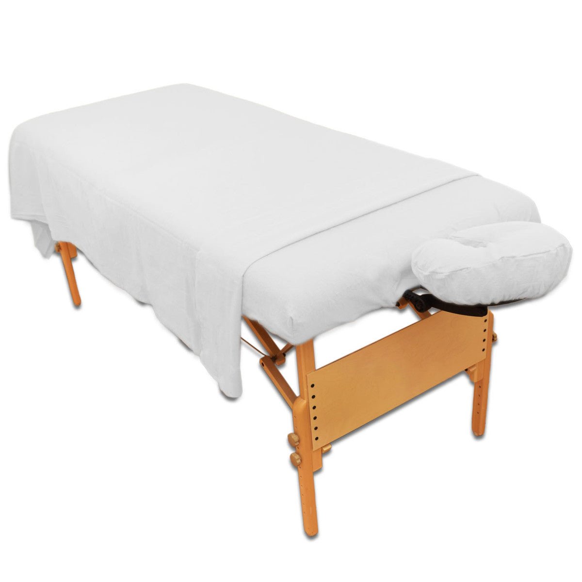 three piece white flannel massage sheet set shown on portable massage table | Equip Wellness Collective